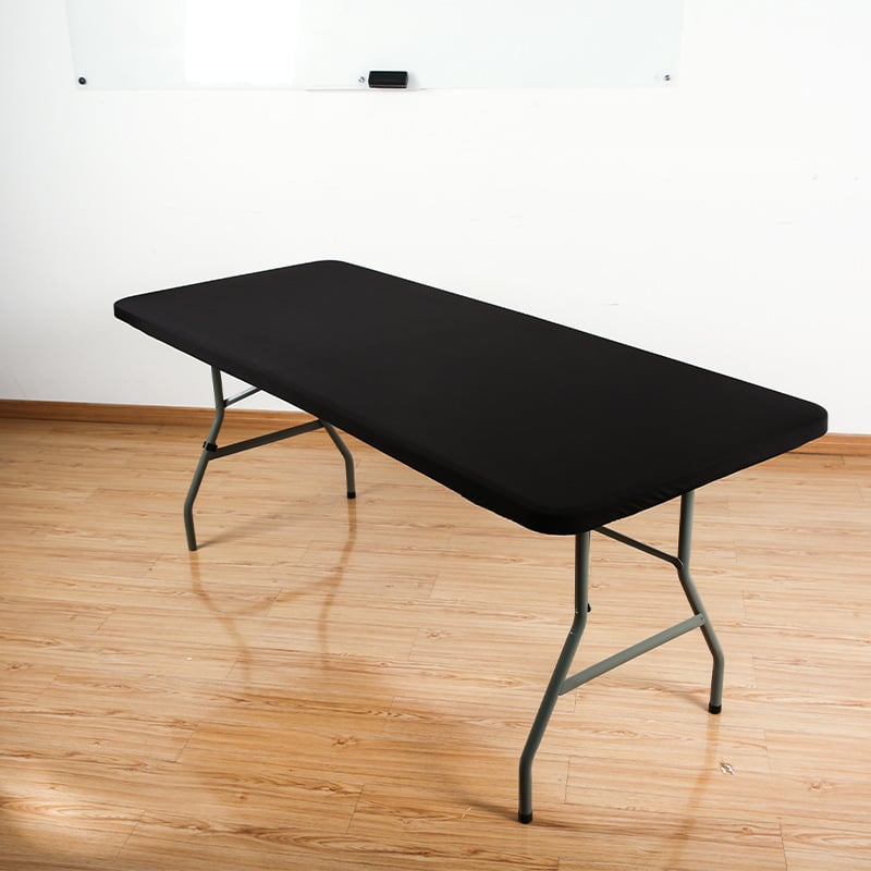Black stretch tabletop cover on folding table