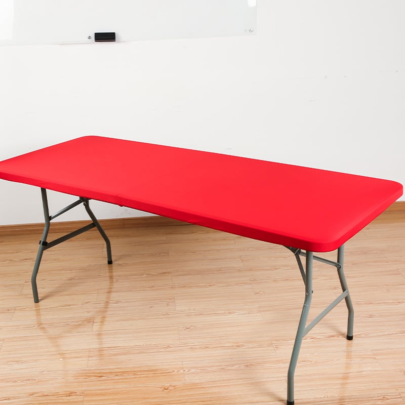Red stretch tabletop cover on folding table