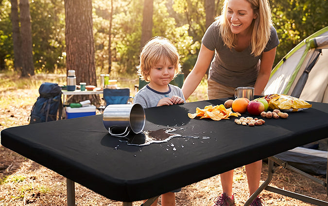 Black covered table prepared for outdoor dining