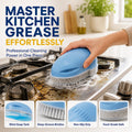 Blue dispensing kitchen brush scrubbing a stovetop